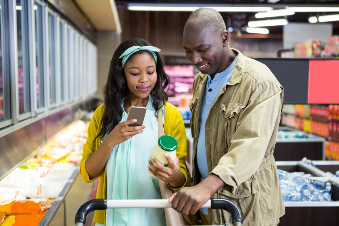 Father and Daughter scanning a label in a grocery store